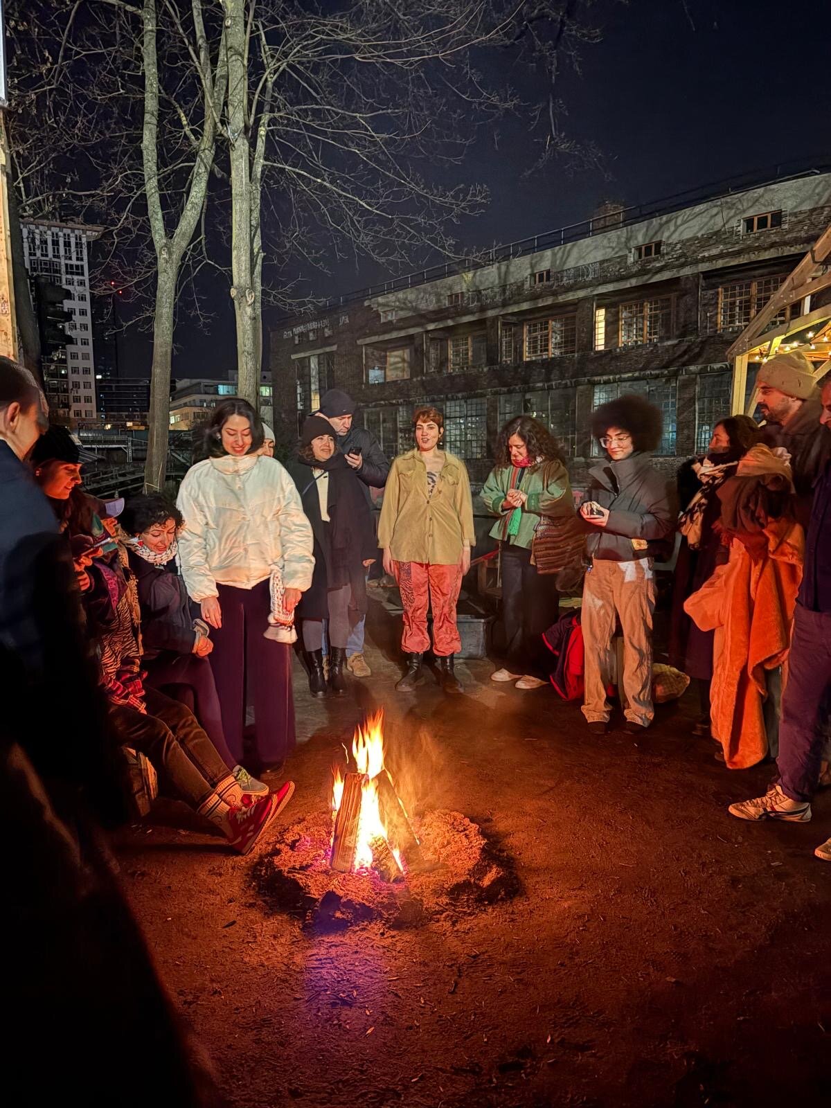 Hamm Collective gathering around a bonfire