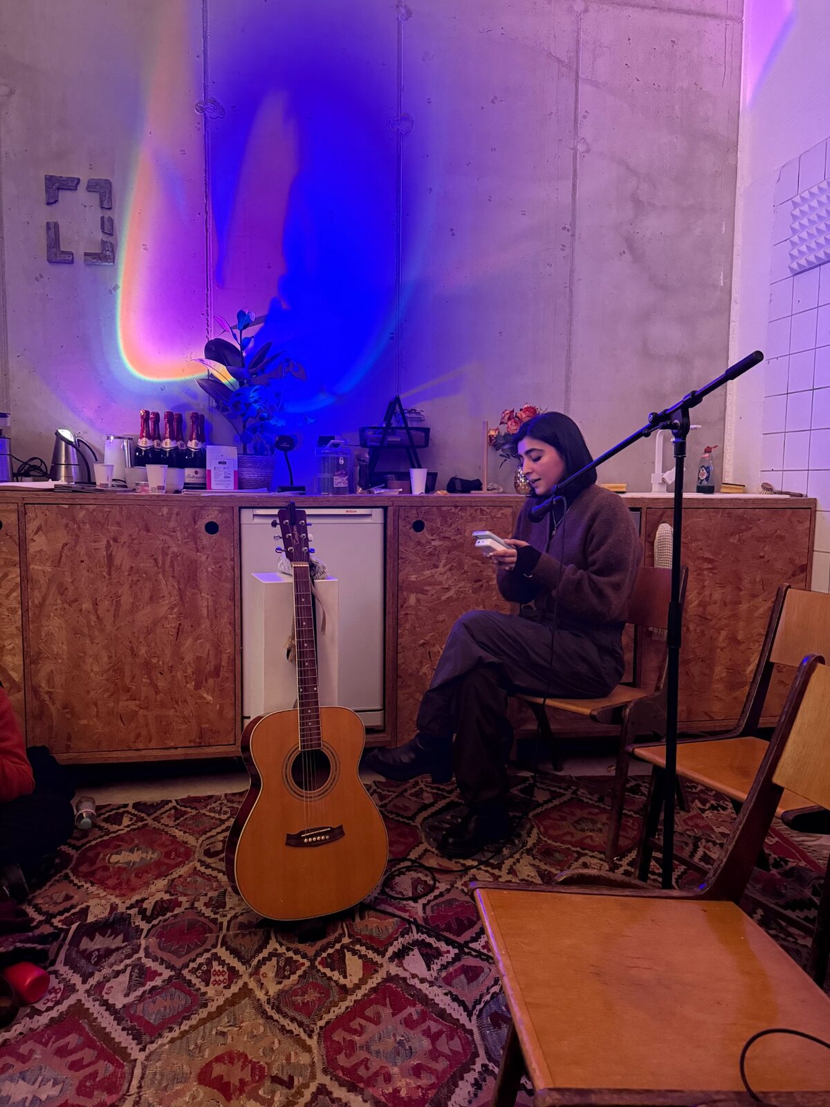 Reading beside a guitar and microphone