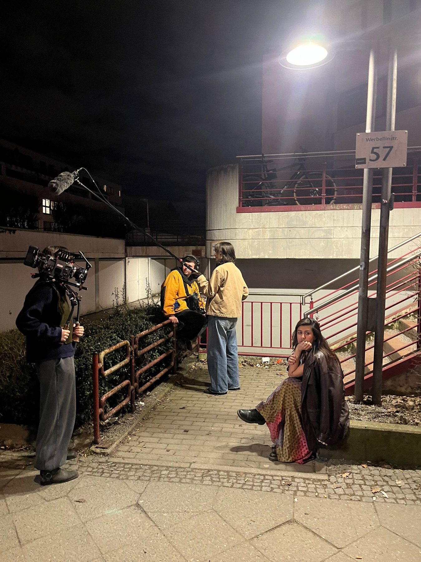 Crew adjusting lighting equipment on set